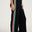 Black wide-leg pants with colorful stripes on a white background