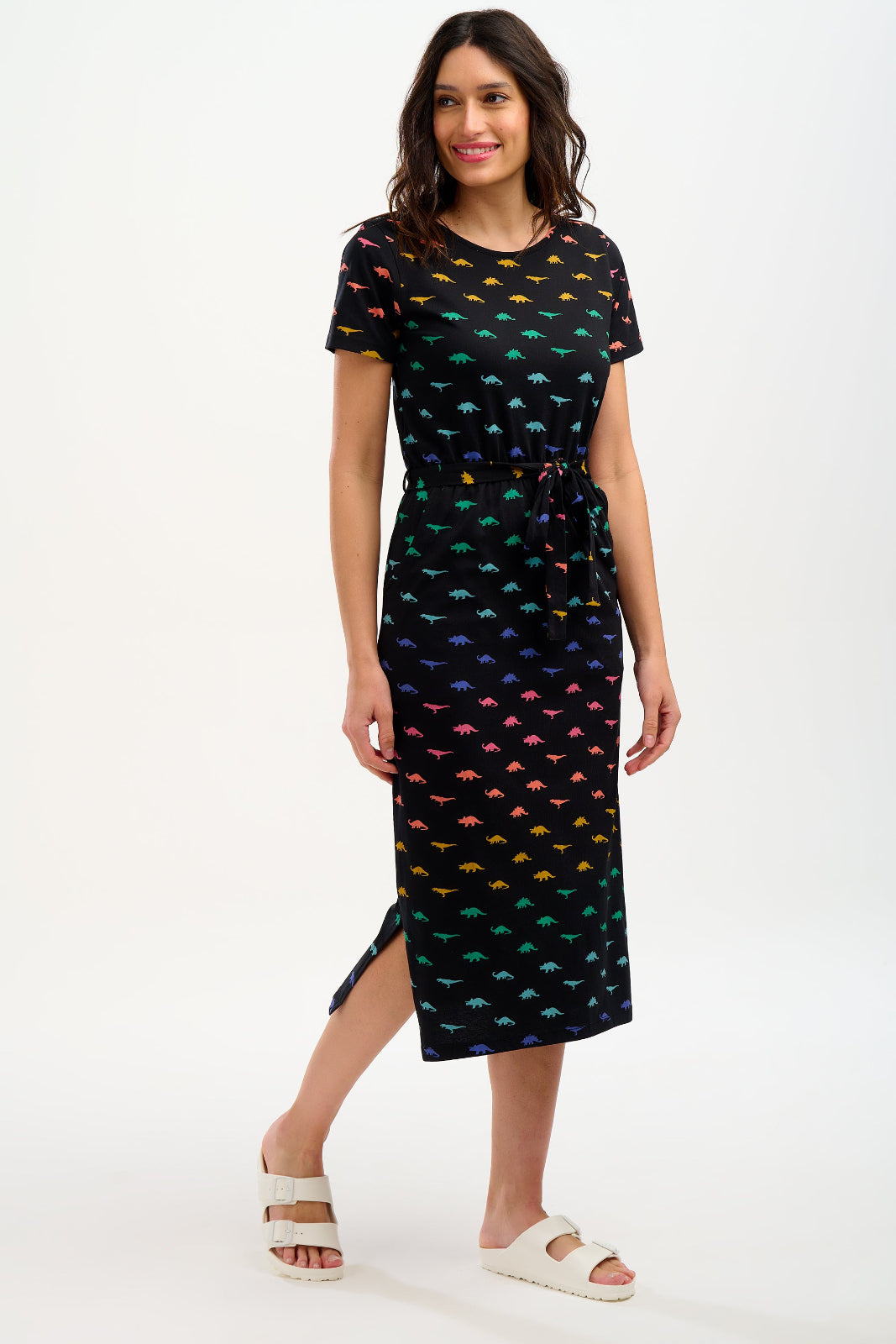 Woman wearing a black dress with colorful fish pattern on a white background