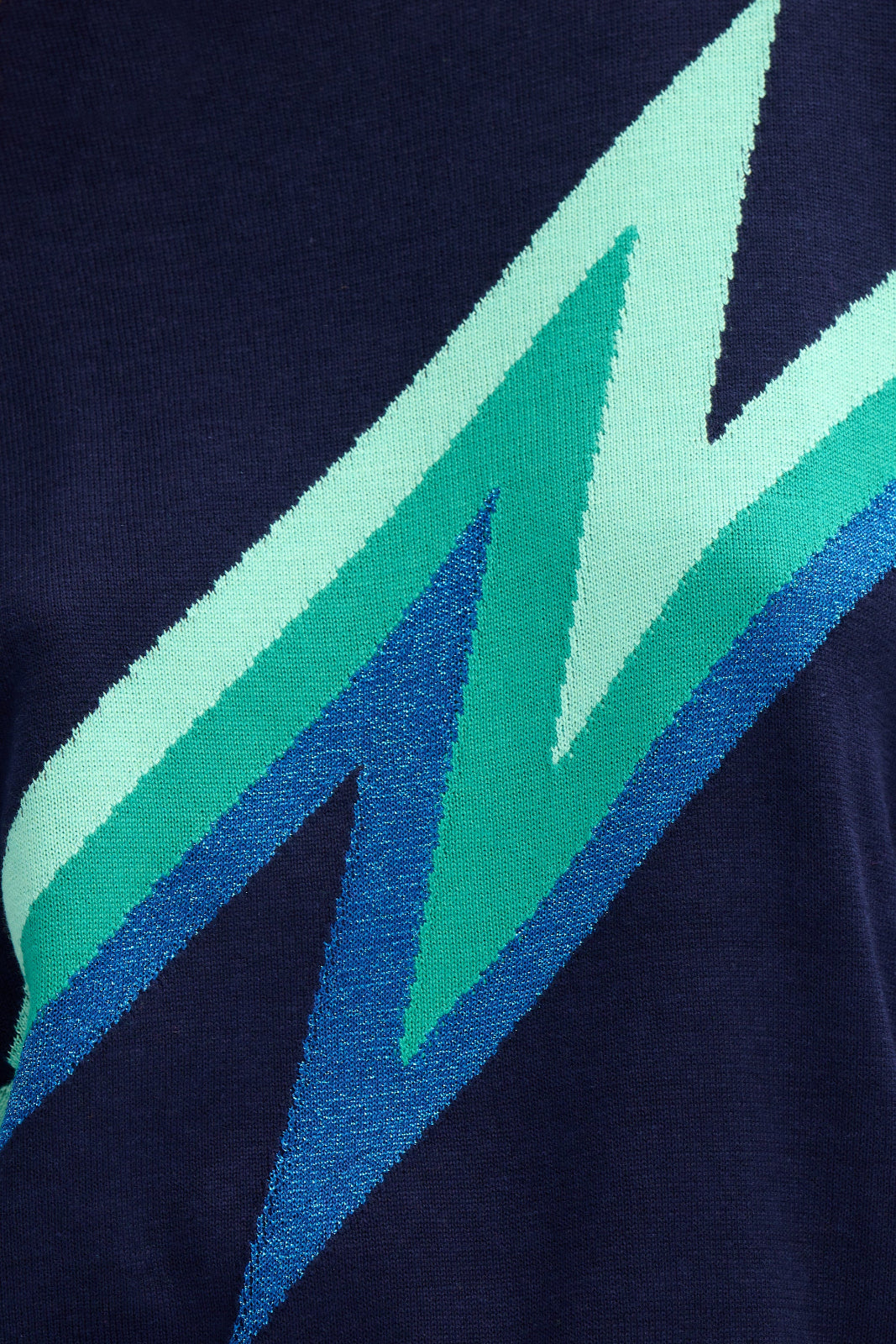 Navy blue fabric with green and blue geometric pattern