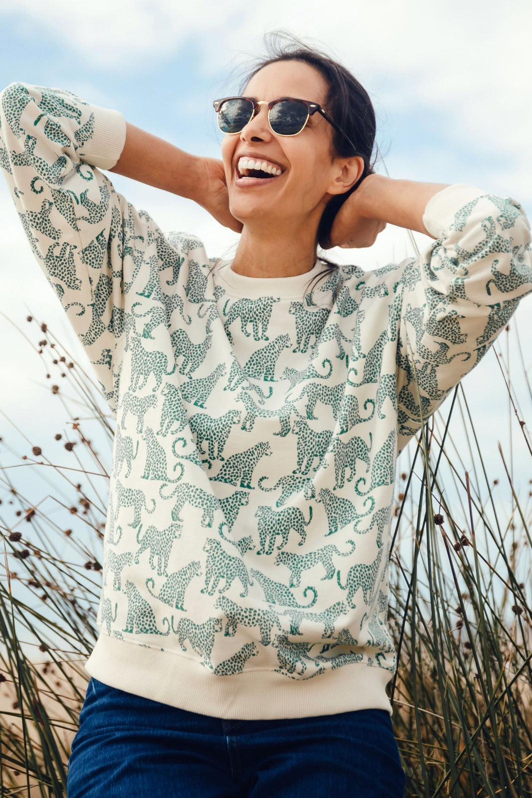 woman wearing white sweatshirt with leopards on