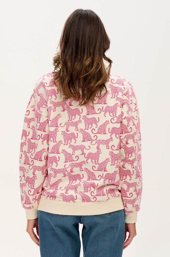 woman modeling white sweatshirt with pink leopards 