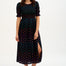 A model wearing a midi shirred dress with a black and rainbow polka print. The dress features a shirred bodice, elasticated puff sleeves, and a split hem.