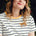 A woman wearing an off-white and navy striped t-shirt with a embroidered leopard on the chest.