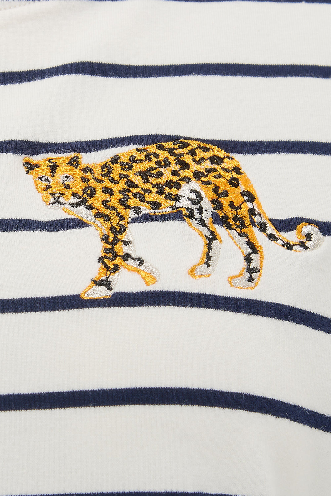 Leopard embroidered on a white fabric with navy stripes